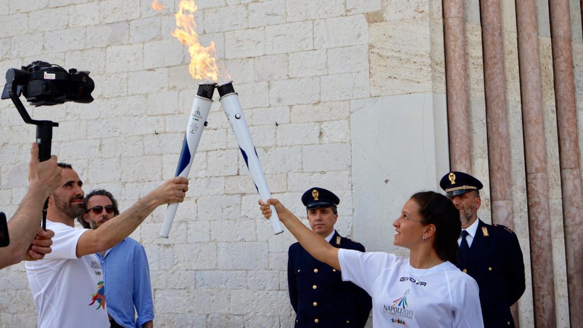AD ASSISI LA FIACCOLA DELL’UNIVERSIADE 2019  IL SINDACO PROIETTI: “LO SPORT FATTORE DI COESIONE SOCIALE”  L’ASSESSORE CAVALLUCCI: “MESSAGGIO FORTE PER I GIOVANI”  PADRE ENZO FORTUNATO: “CHE LA LAMPADA SIA DI PACE”